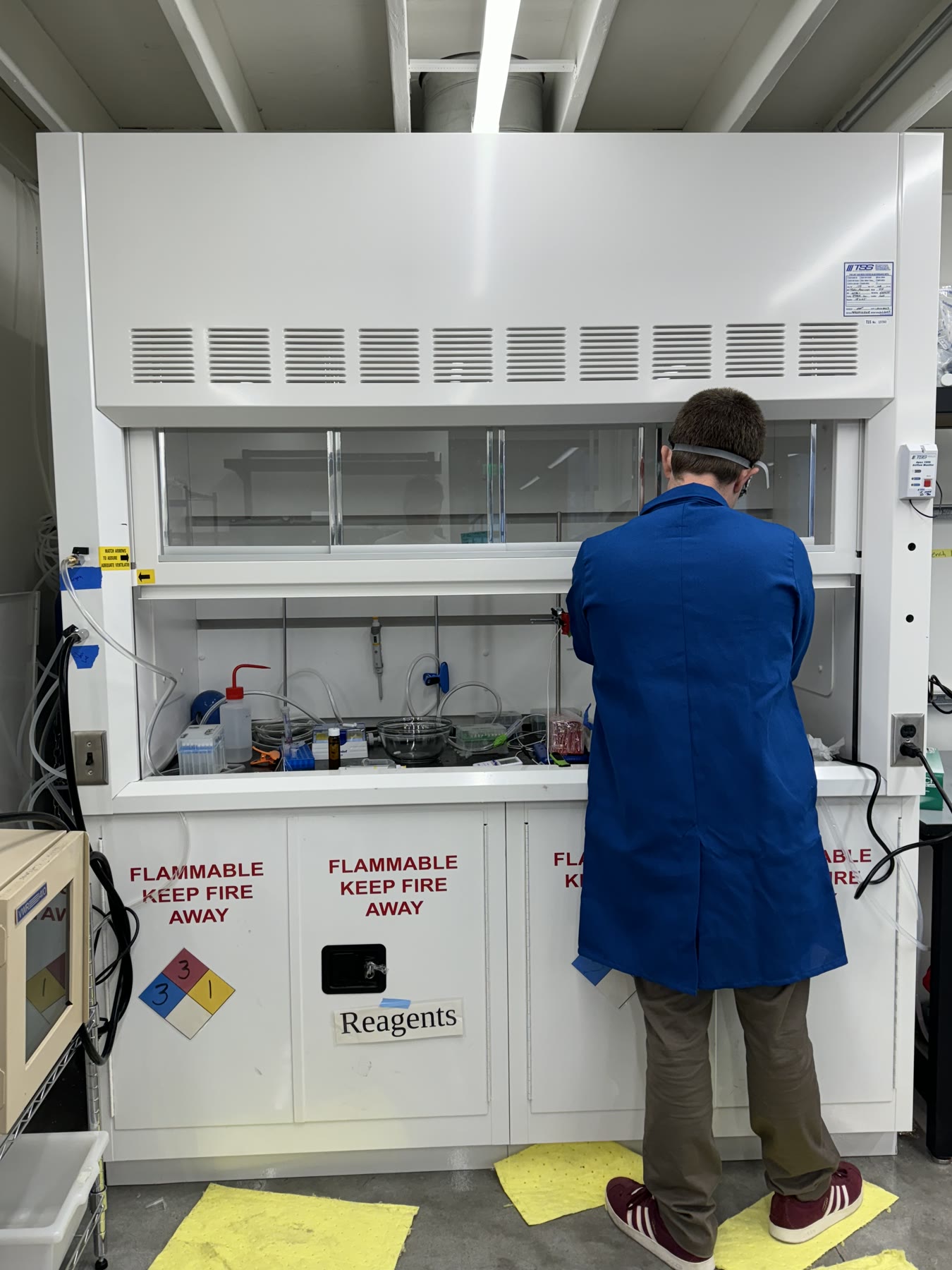 Researcher working at a laboratory fume hood