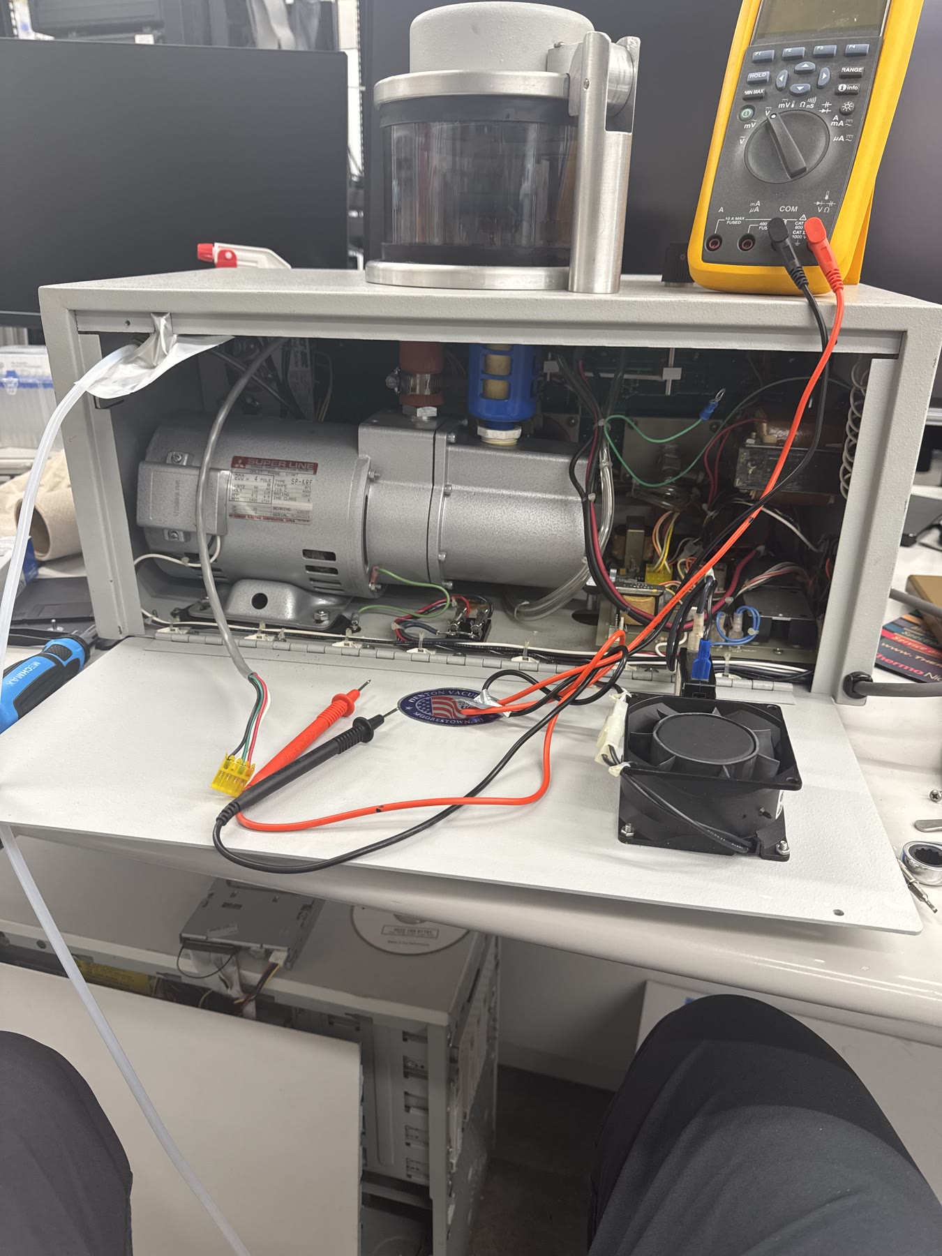 Open benchtop instrument undergoing electrical repair