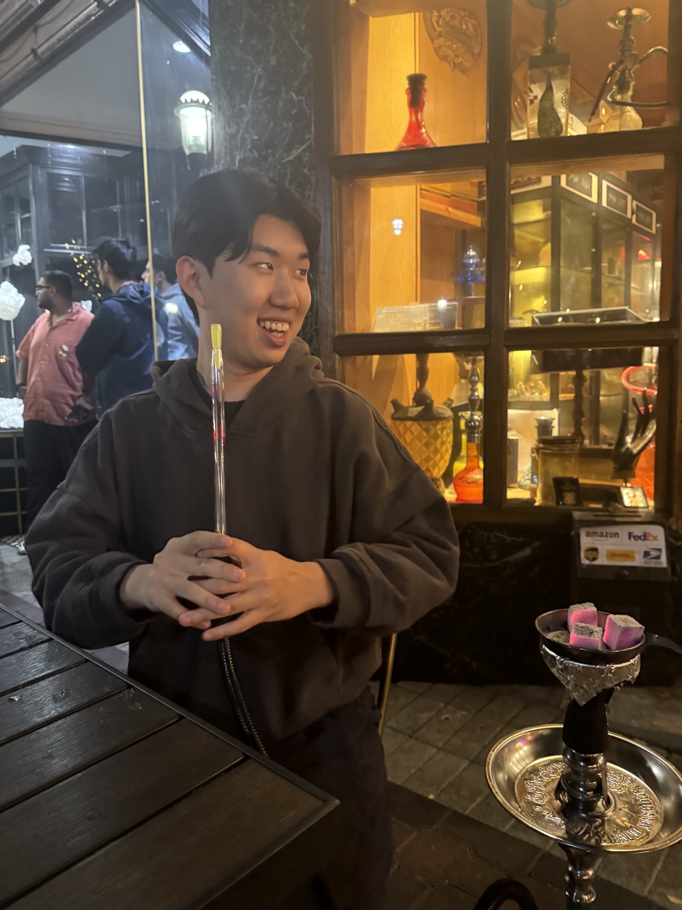 Friend smiling at a hookah lounge