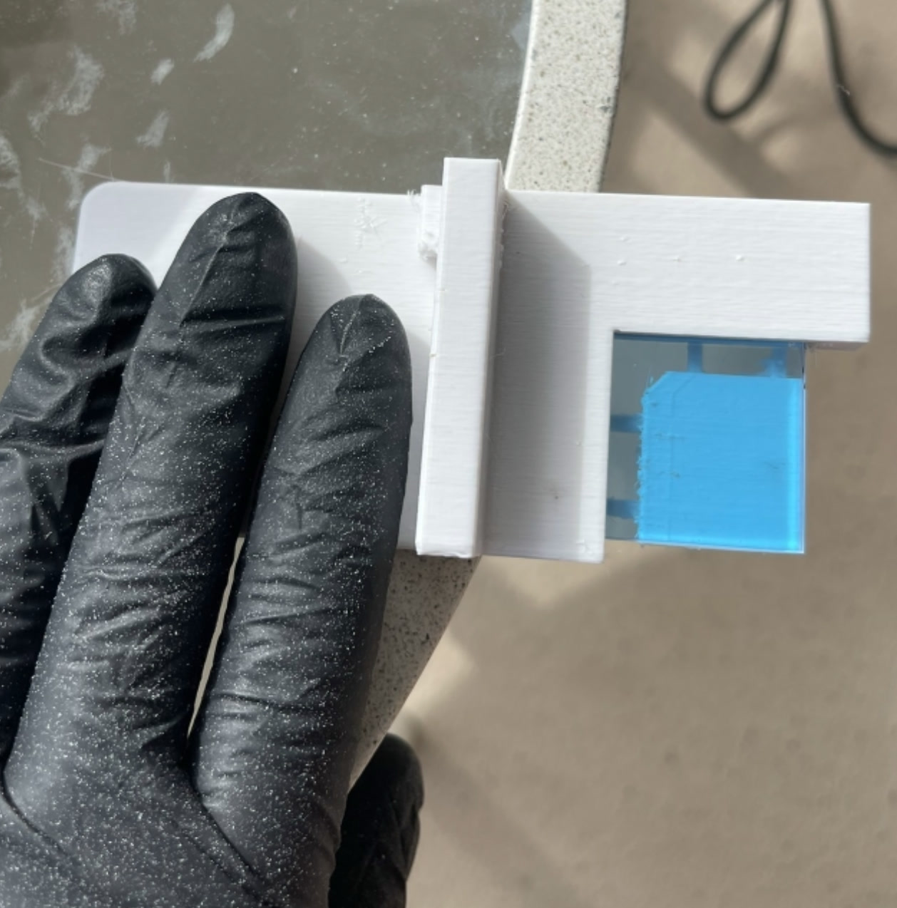 UV hot-pass mirror held in a 3D-printed cutting fixture