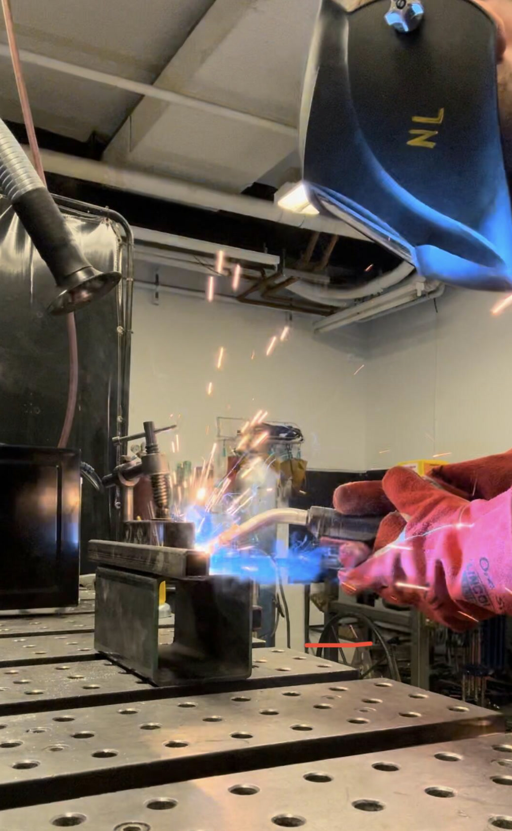 Welding a steel test fixture on a fabrication table